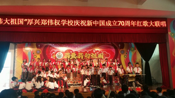 圖為三2班家長(zhǎng)代表吳俊英(后排右七))在禮堂與孩子共同演唱紅歌我愛我的祖國(guó).jpg